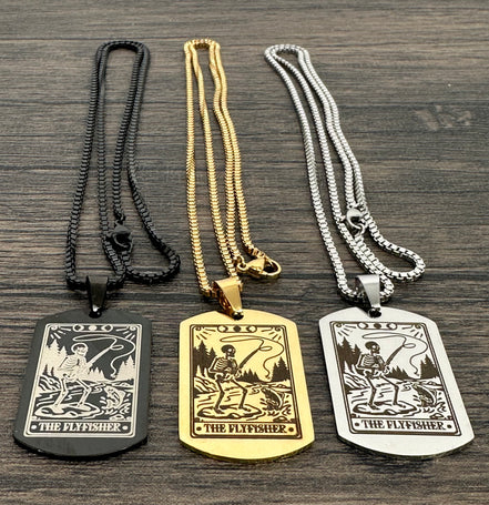 Three necklaces with 'The Flyfisher' pendant on a wooden surface