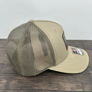 Side view of a Brook trout fly fishing hat with an engraved fly