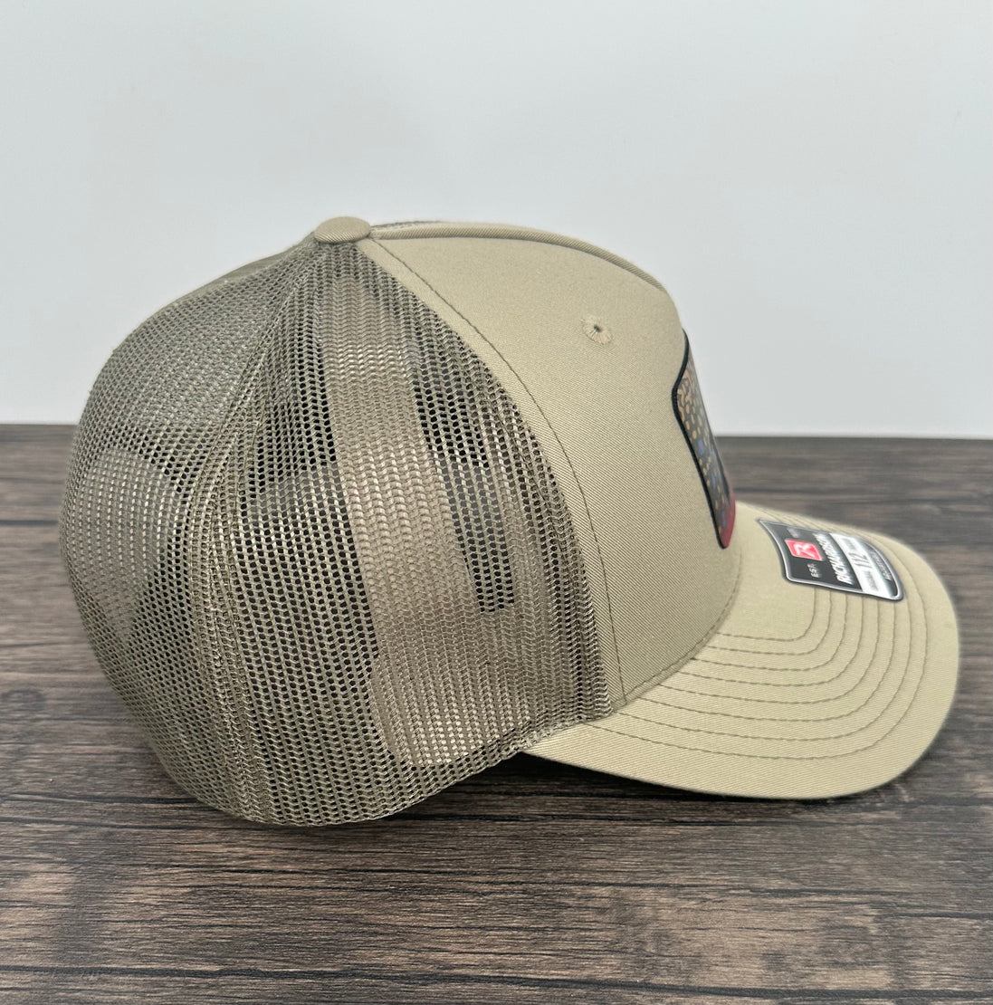 Side view of a Brook trout fly fishing hat with an engraved fly