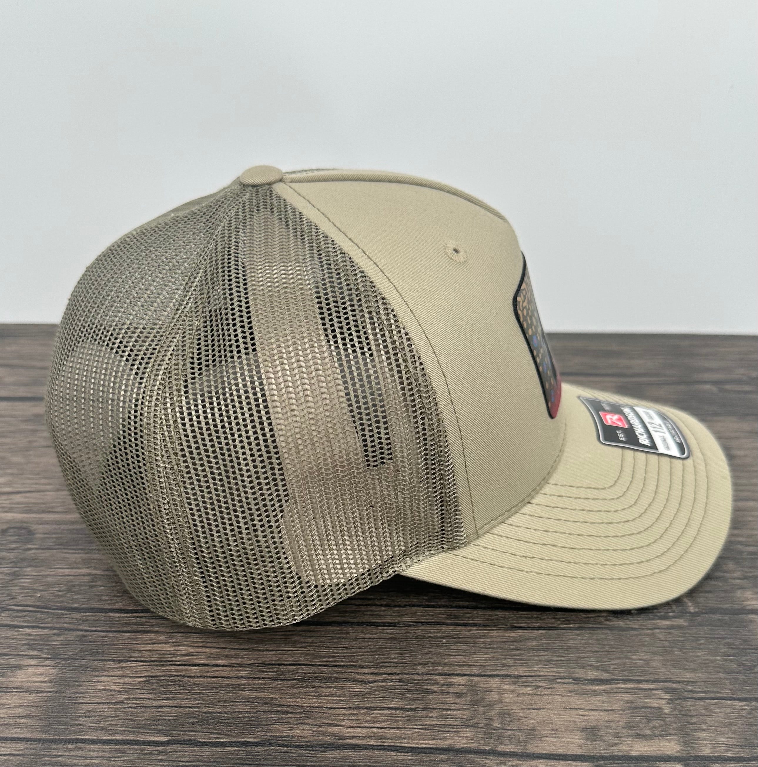 Side view of a Brook trout fly fishing hat with an engraved fly