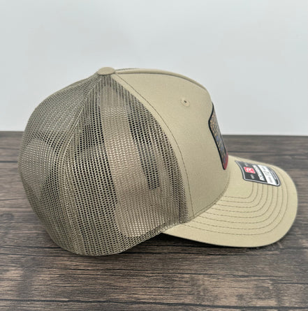 Side view of a Brook trout fly fishing hat with an engraved fly