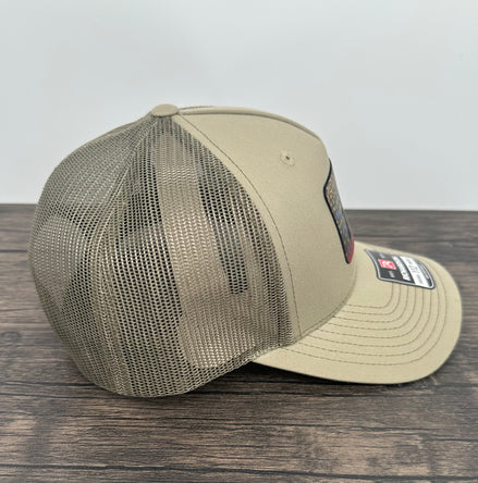 Side view of a Brook trout fly fishing hat with an engraved fly