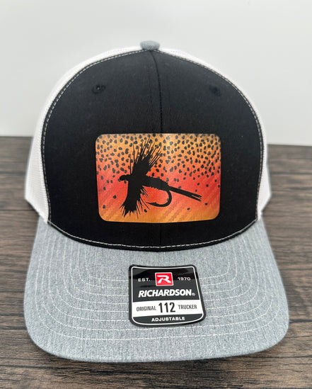 Black gray and white hat with a cutthroat trout fly patch
