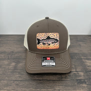 Brown and beige brown trout fly fishing hat featuring a laser engraved trout outline on a printed brown trout patch