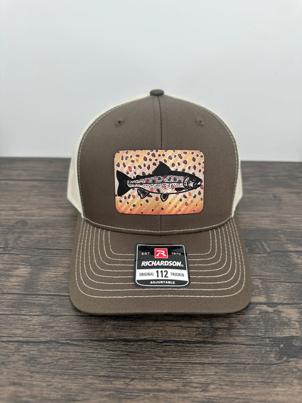 Brown and beige brown trout fly fishing hat featuring a laser engraved trout outline on a printed brown trout patch