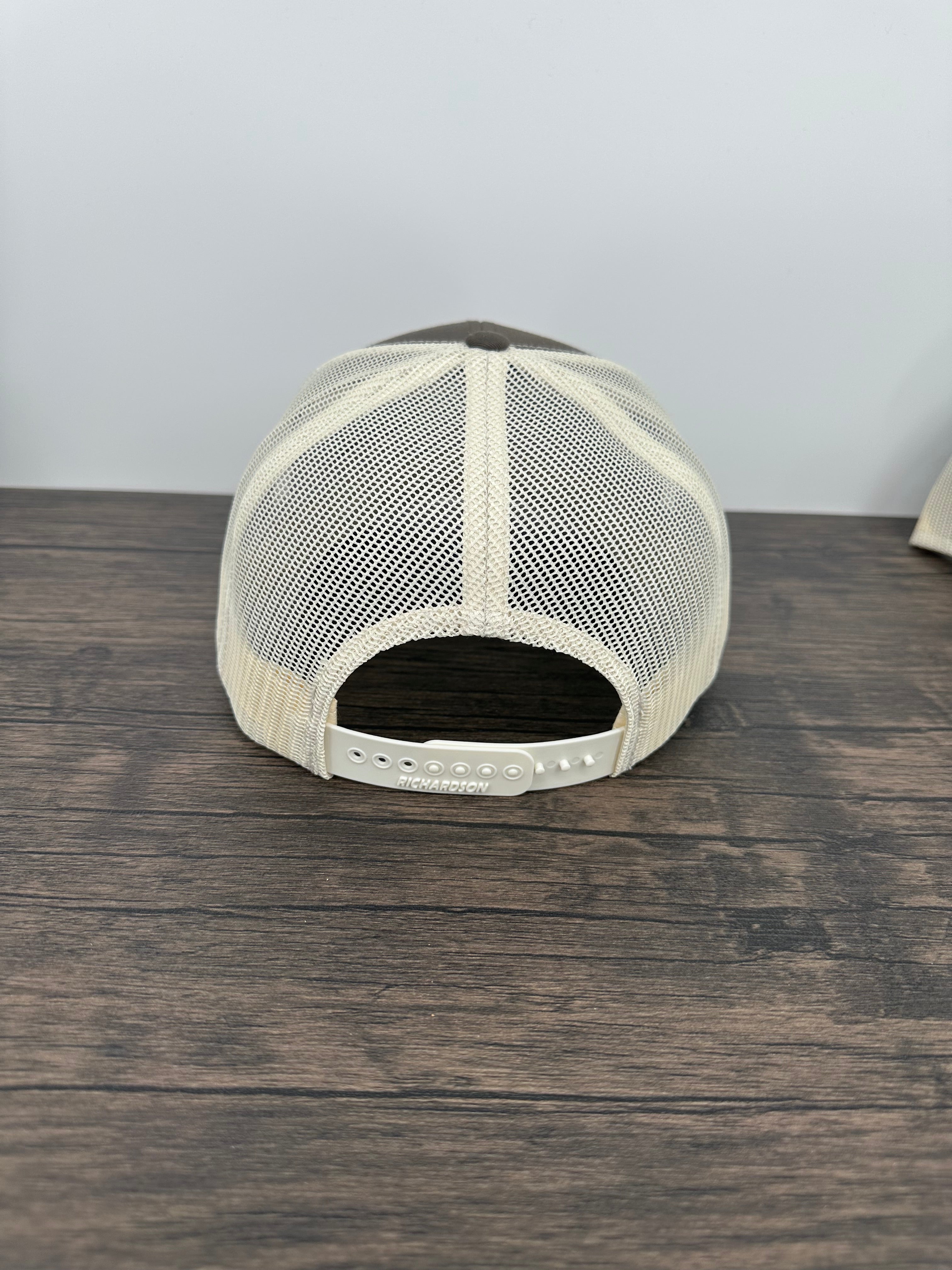 Back view of the Brown and beige brown trout fly fishing hat featuring a laser engraved trout outline on a printed brown trout patch