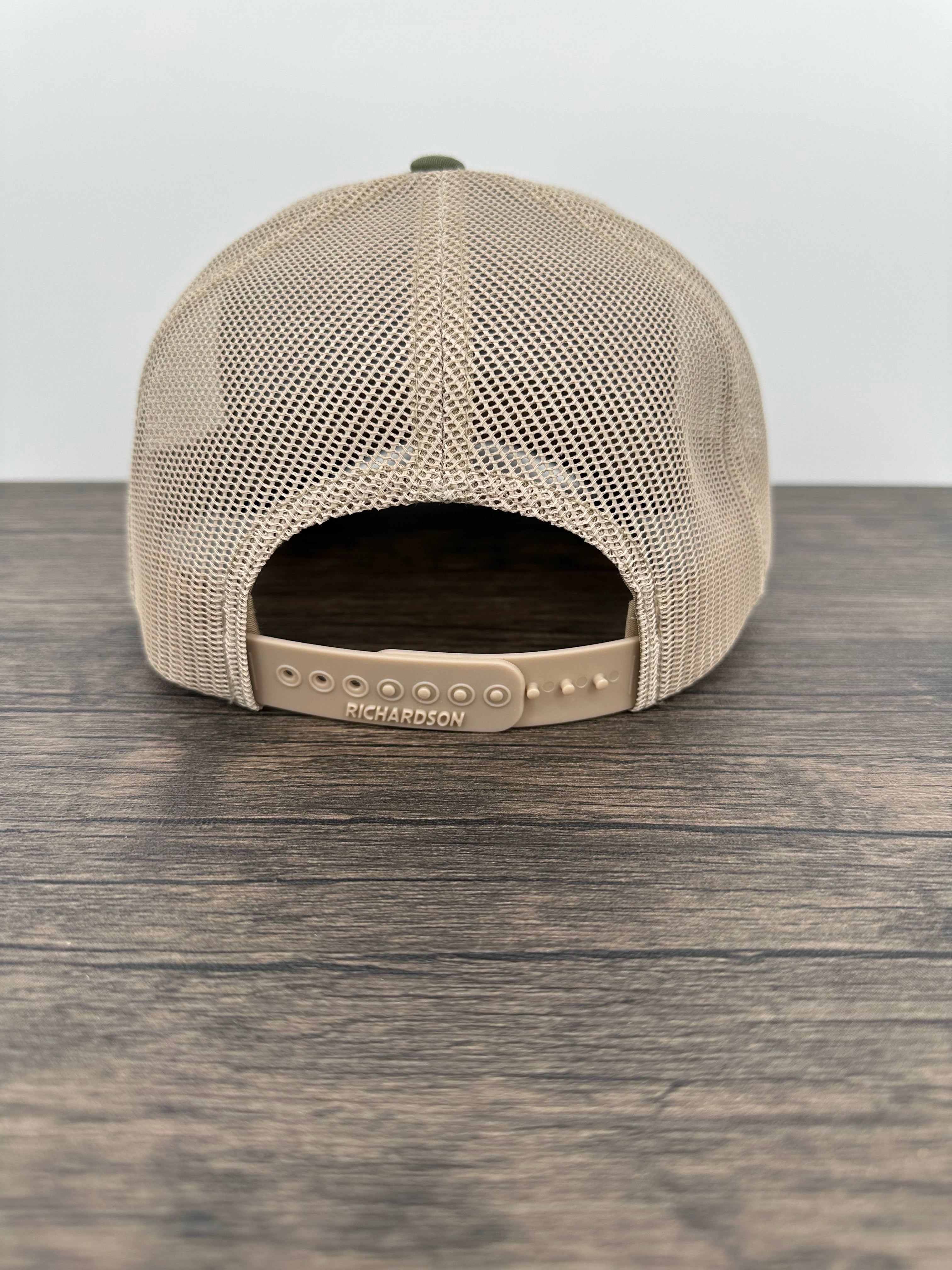 Back view of a Green and beige trucker hat with moose  wearing a beanie and sunglasses that has been laser engraved on a leatherette patch on the front of the hat