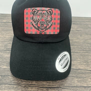 Black hat with a red and black buffalo plaid patch that has mama bear engraved on the patch