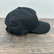 Side view of a Black hat with a red and black buffalo plaid patch that has mama bear engraved on the patch