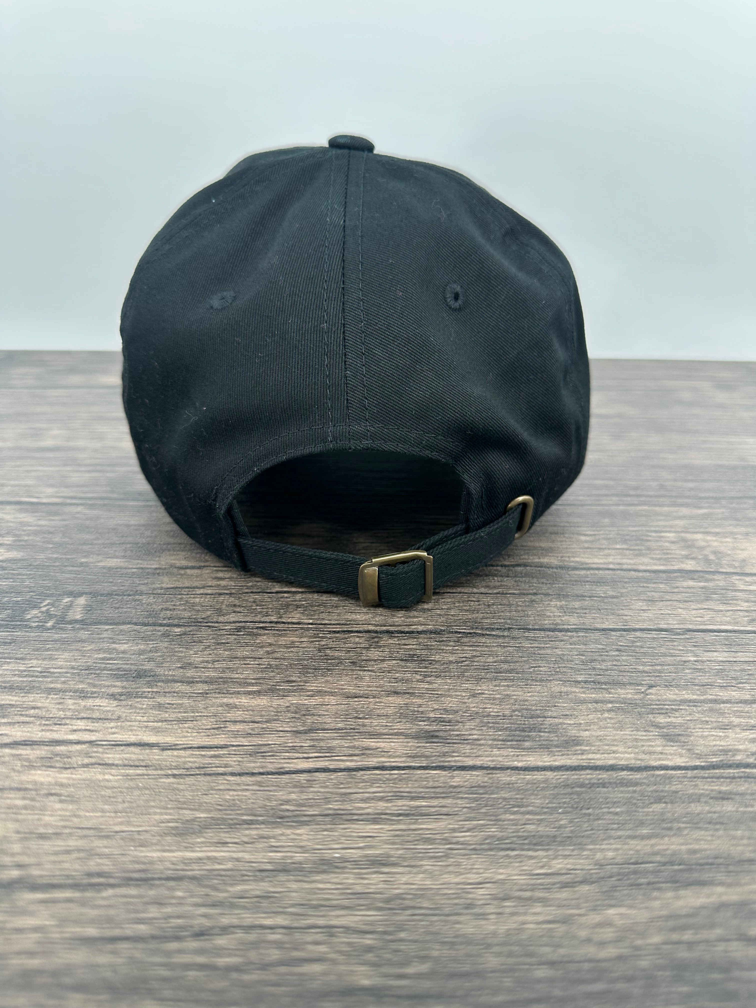 Back view of a Black hat with a red and black buffalo plaid patch that has mama bear engraved on the patch