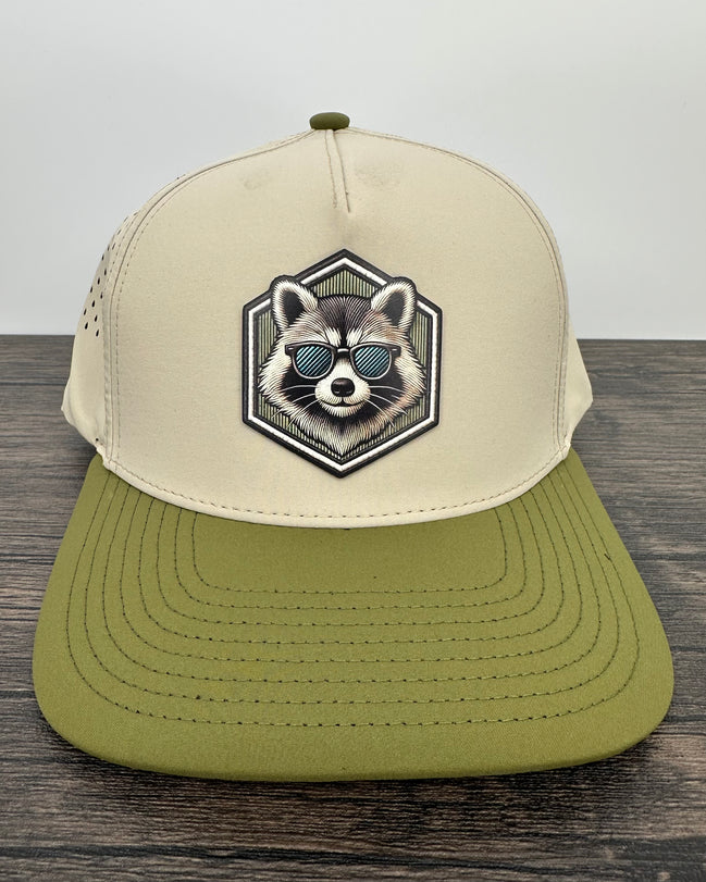 Beige and green cap with raccoon design