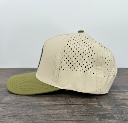 Beige and green baseball cap on a wooden surface with a light gray background