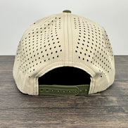 Beige cap with green brim on a wooden surface