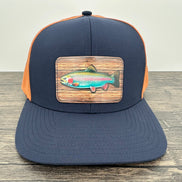 Navy and orange fly fishing hat with a rainbow trout patch