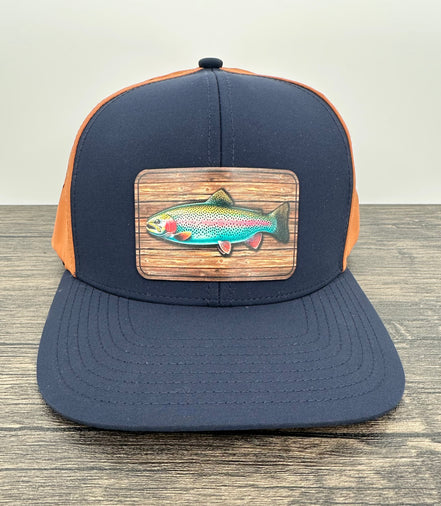 Navy and orange fly fishing hat with a rainbow trout patch