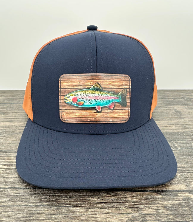 Navy and orange fly fishing hat with a rainbow trout patch
