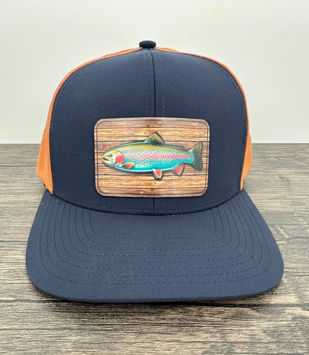 Navy and orange fly fishing hat with a rainbow trout patch