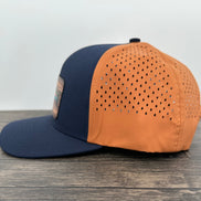 Navy and orange fly fishing cap side view