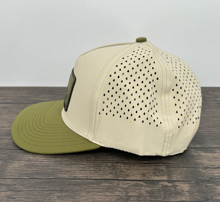Beige cap with green brim on a wooden surface