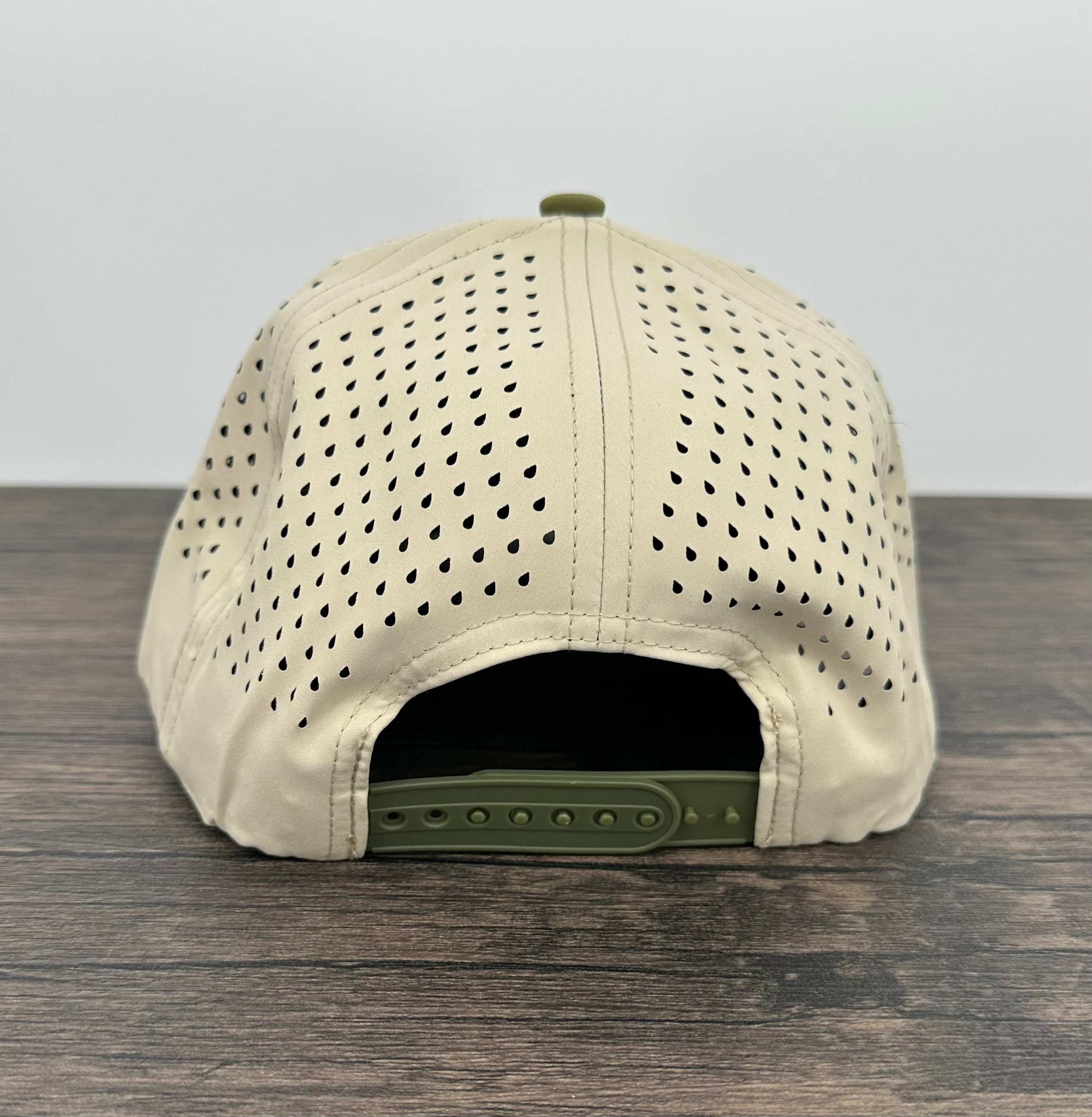 Beige cap with green brim on a wooden surface