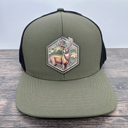 Green and black cap with a deer patch