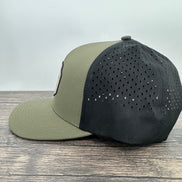 Side view of a green and black deer hunting hat