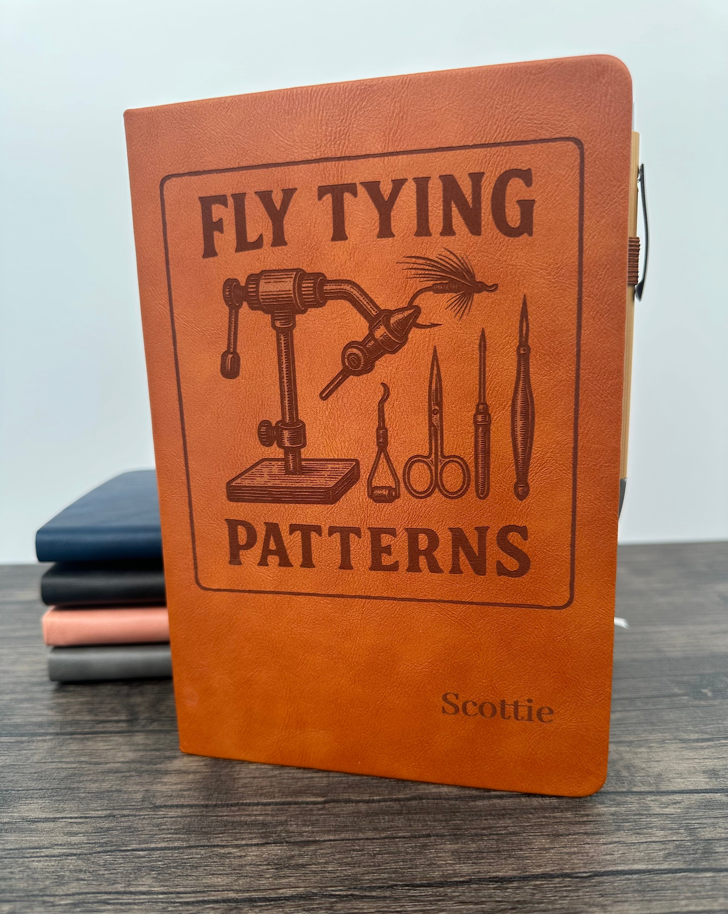 Brown leatherette notebook with 'Fly Tying Patterns' design and  engraved name on the cover of the journal