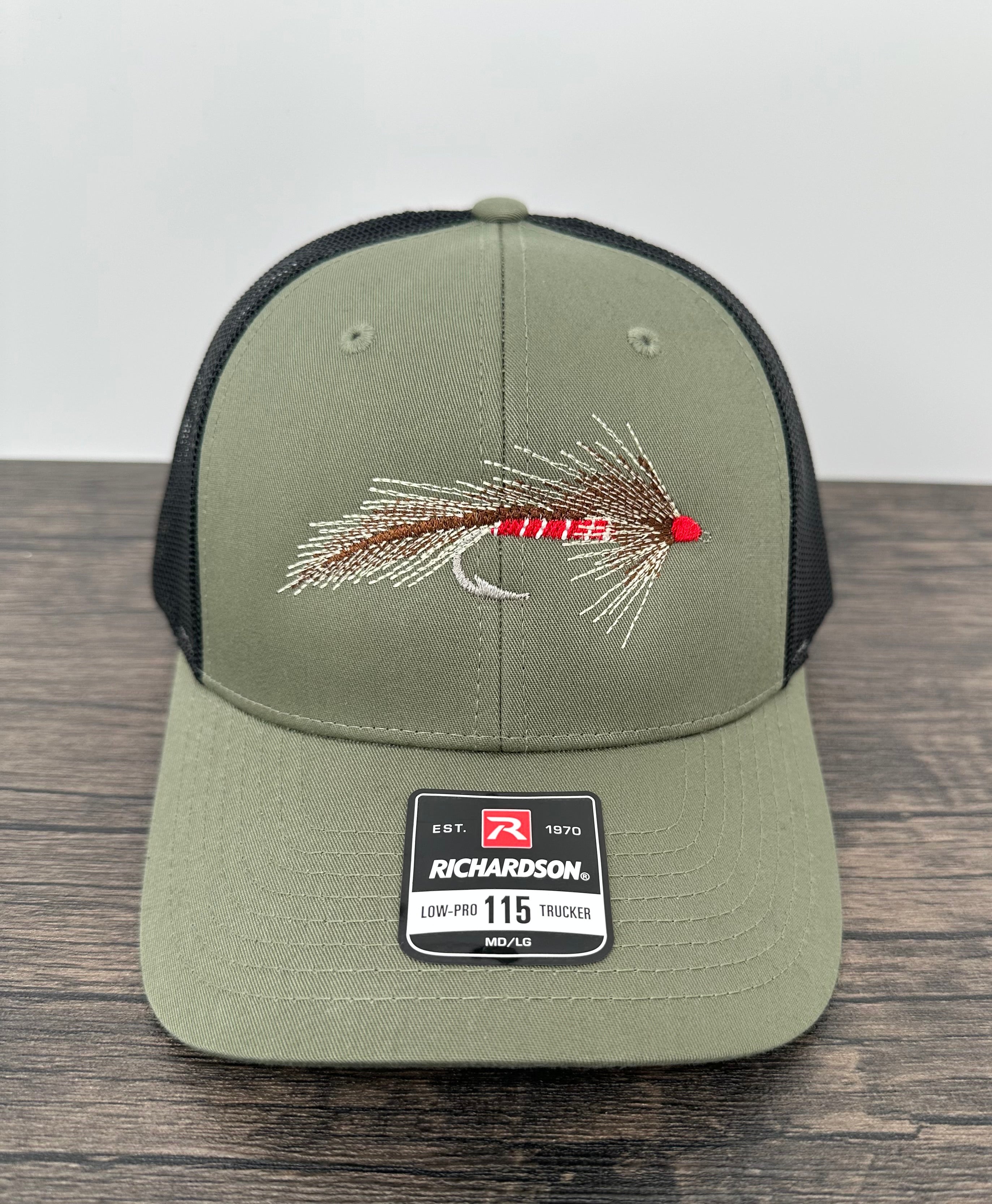 Embroidered fly on a green and black Richardson 115 fly fishing hat