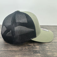 Side view of an embroidered fly fishing hat in green and black