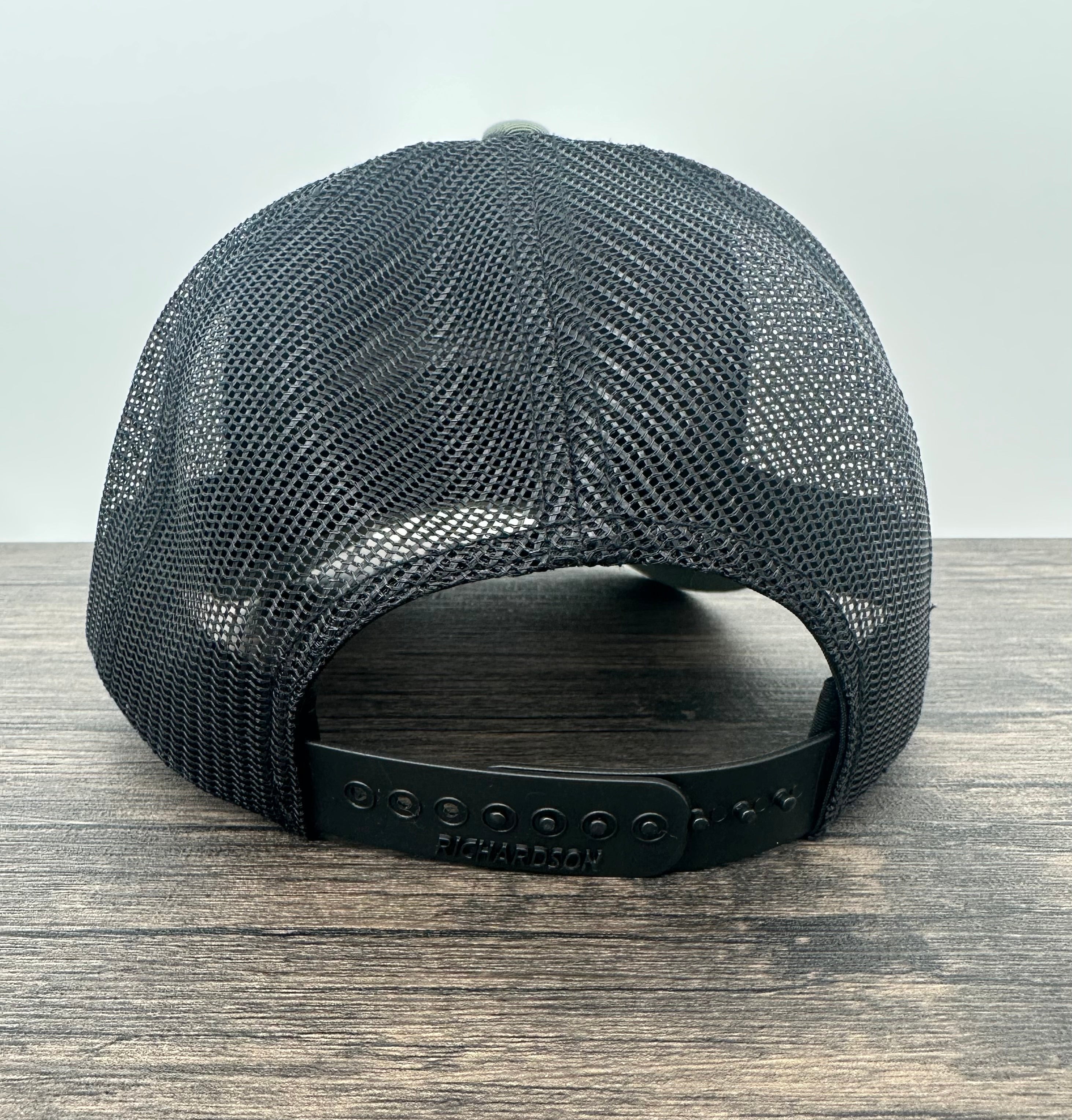 Back view of a green and black embroidered fly fishing hat