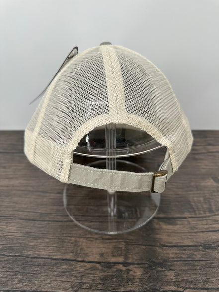 Beige mesh cap on a stand against a wooden panel background