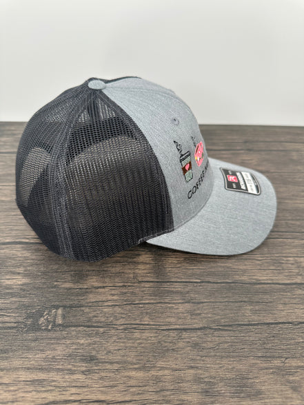 Gray and black coffee embroidered cap with mesh back on a wooden surface