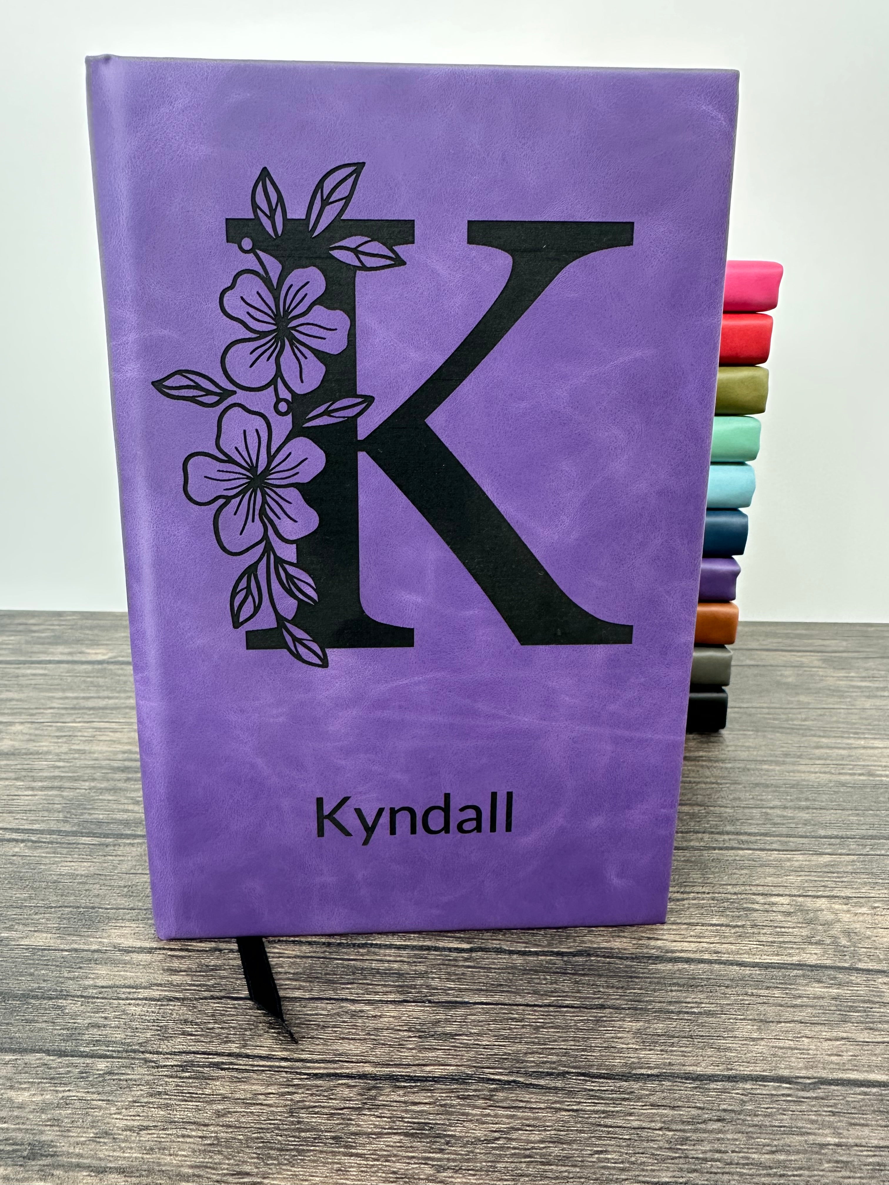 Purple laser engraved journal with floral design and 'Kyndall' engraved on the cover