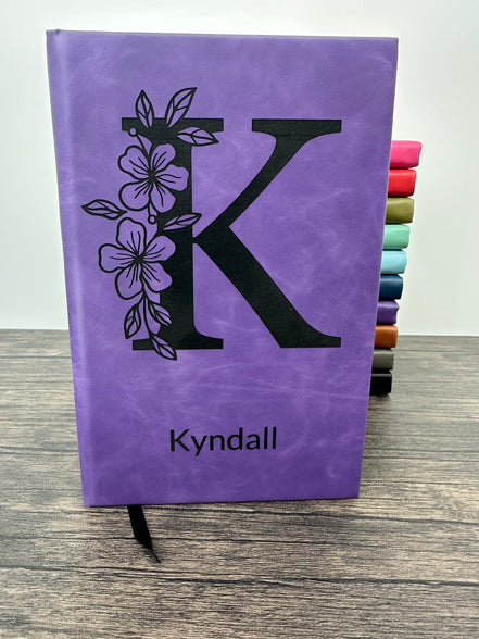 Purple laser engraved journal with floral design and 'Kyndall' engraved on the cover
