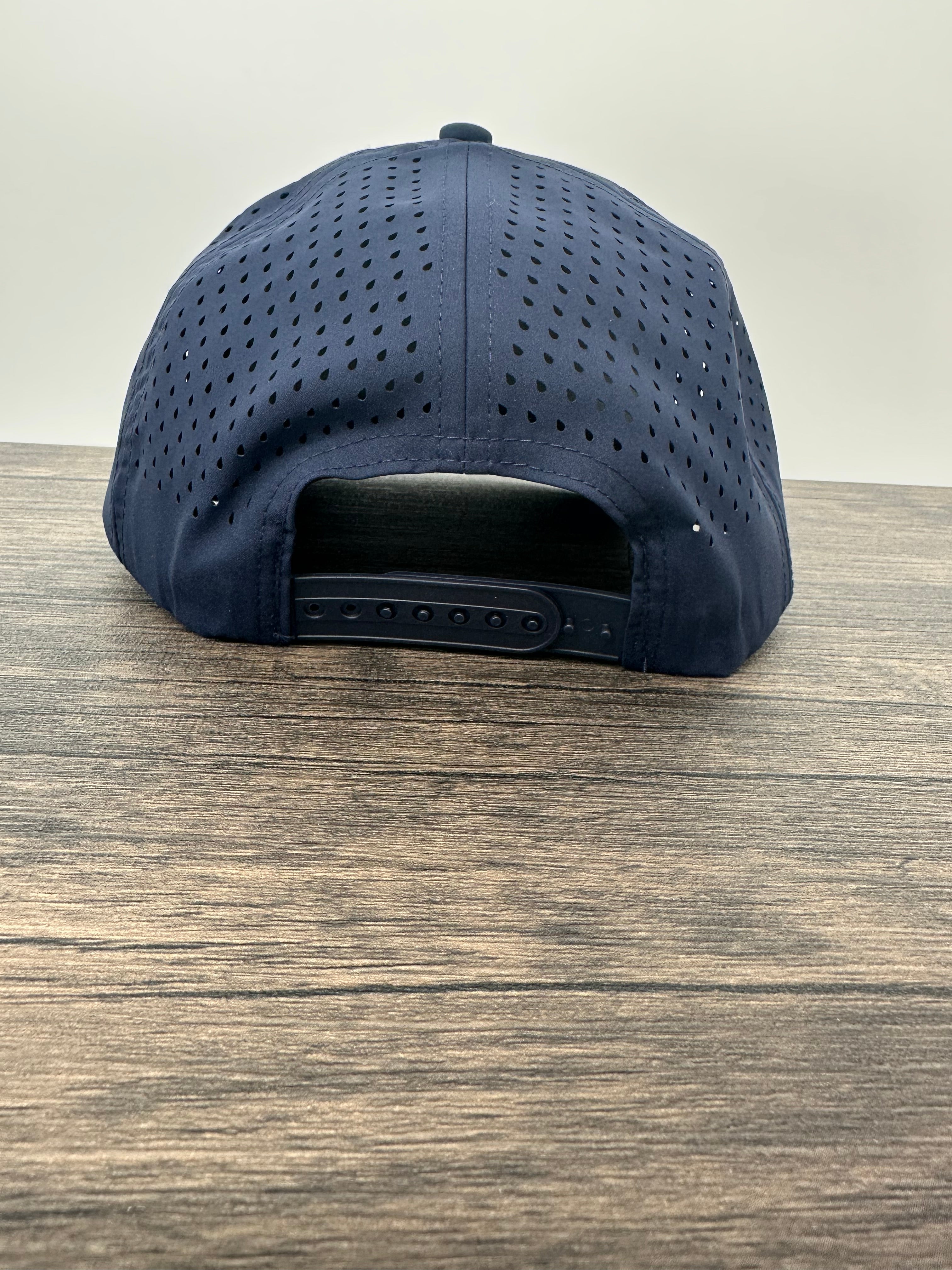 Back view of a navy blue fly  fishing hat that has a fly fishing rod and reel patch 