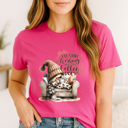 Pink shirt with gnome holding coffee and text that reads I’ll start working when my coffee does