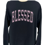 Black long-sleeve shirt with 'BLESSED' printed in pink leopard print on a white background