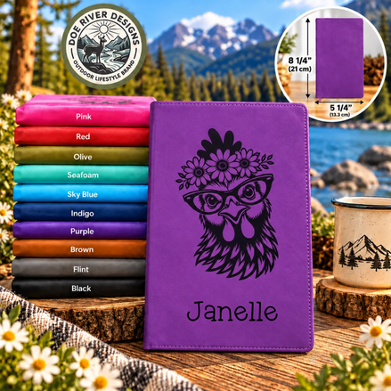 Purple tablet case with a black engraved owl wearing glasses and a flower crown, with the name 'Janelle' printed below. The case is displayed in front of a stack of folded color options labeled Pink, Red, Olive, Seafoam, Sky Blue, Indigo, Purple, Brown, Black, and Pink, with a Dog River Designs logo at the top left.