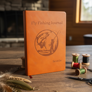 Custom Engraved Fly Fishing Journal at subtle angle on rustic desk