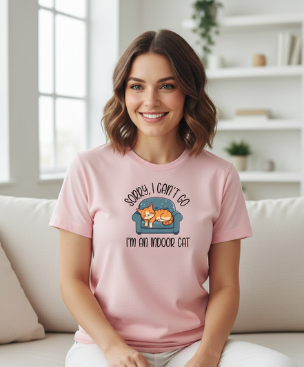 Female model wearing Sorry I Can't Go shirt in light pink