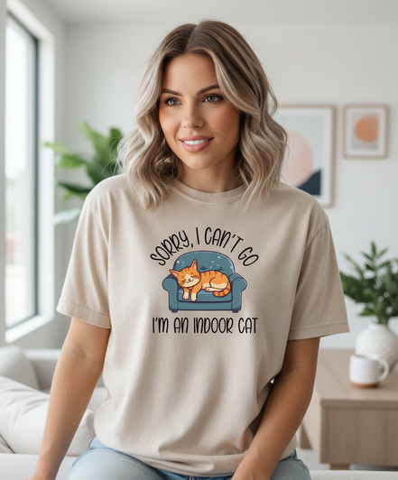 Female model wearing Sorry I Can't Go shirt in sand