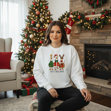 Female model wearing white Just A Jolly Goose sweatshirt in Christmas setting