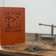 Fly Tying Patterns Journal on Rustic Desk
