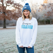 Model wearing white Freezin' Season sweatshirt